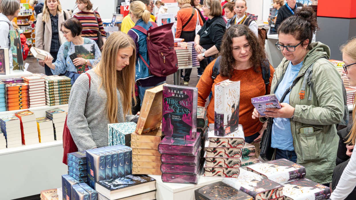 Impression von Besucher:innen an Büchertischen auf der Leipziger Buchmesse 2025