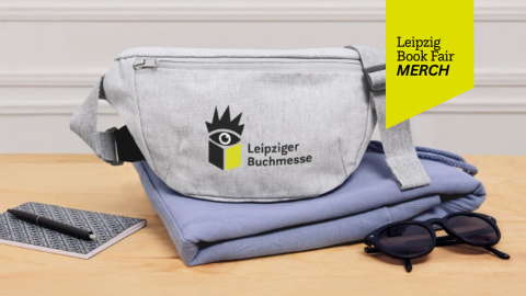 Leipzig Book Fair Merch Shop: grey fannypack with LBM print on a desk