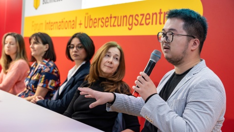 Stage discussion with 5 participants on the stage of the Forum International + Translation Center at the Leipzig Book Fair 2024