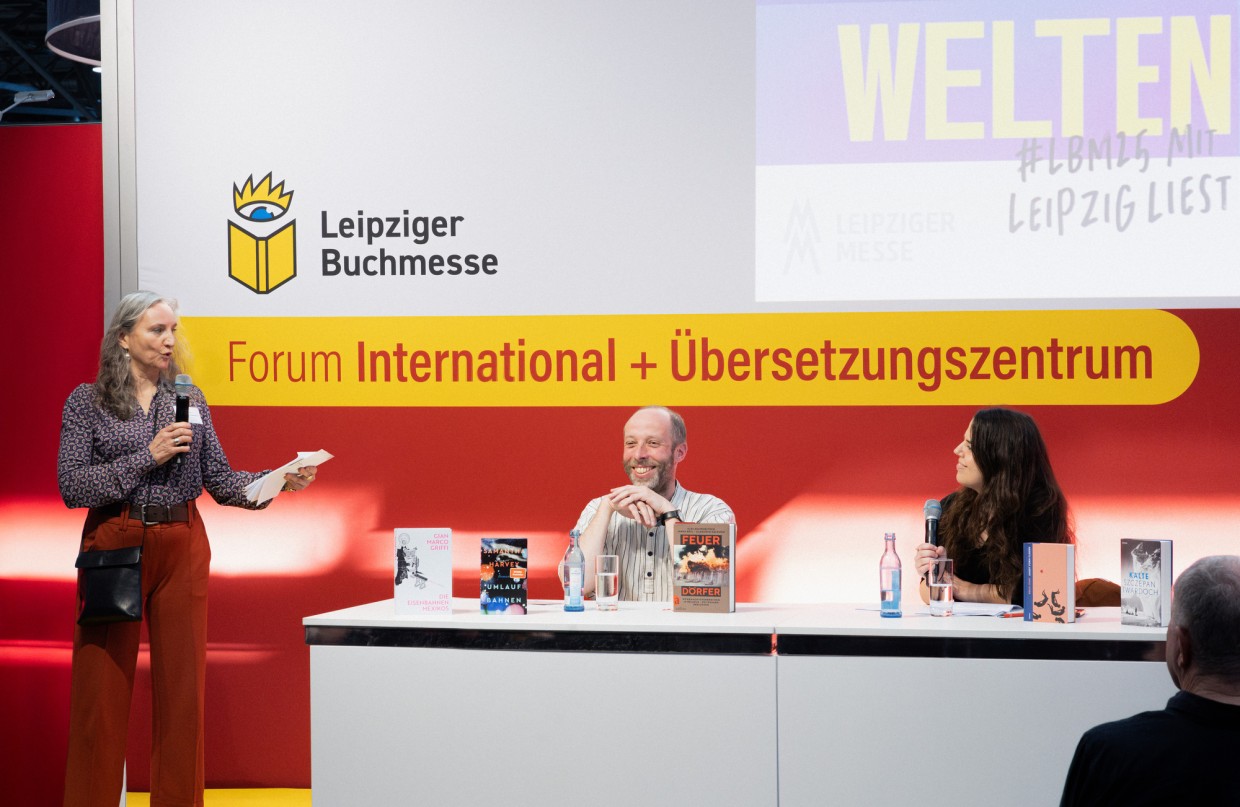 Stage discussion with three participants on the stage of the Forum International + Translation Center at the Leipzig Book Fair 2025