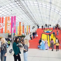 Impression of the interior of the glass hall at Leipzig Exhibition Center with red staircase at the 2025 Book Fair