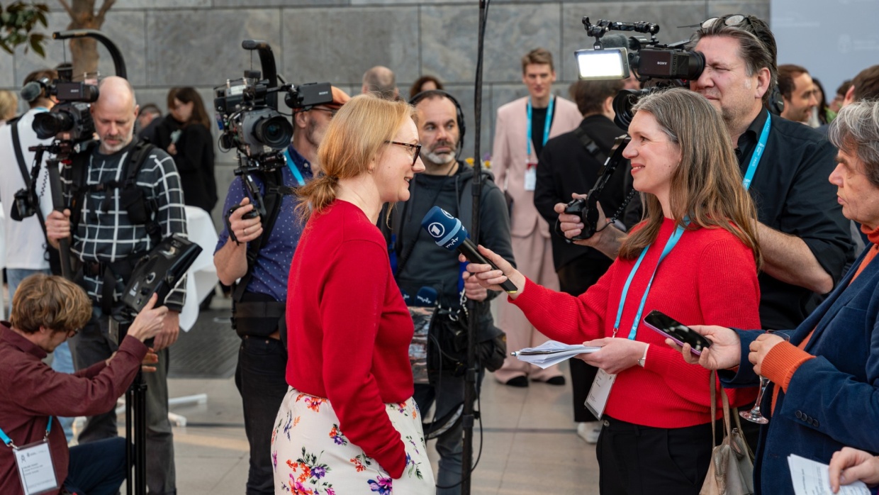 Winner of the Leipzig Book Fair Prize 2025 Kristine Bilkau gives an interview for ARD, surrounded by cameras