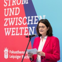 Christina Beinhoff speaking on stage at the trade fair stand of the Focus Topic Danube at Leipzig Book Fair 2026