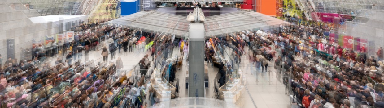 View of the crowded glass hall with colorful banners at Leipzig Book Fair 2026